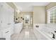 Bright bathroom with white cabinets, soaking tub, and dual sink vanity at 39 Gabrielle Ct, Stockbridge, GA 30281