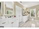 Bathroom featuring double sinks, white cabinets, and tile flooring at 39 Gabrielle Ct, Stockbridge, GA 30281
