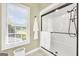 Bathroom featuring white shower, towel rack, and a bright window view at 39 Gabrielle Ct, Stockbridge, GA 30281