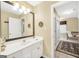 Bright bathroom featuring a vanity with modern fixtures, and an open doorway to the ensuite at 39 Gabrielle Ct, Stockbridge, GA 30281
