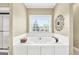 Modern bathroom featuring a white tub with tile surround and a bright window view at 39 Gabrielle Ct, Stockbridge, GA 30281