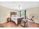 Bright bedroom with hardwood floors, ceiling fan, and a window with a view at 39 Gabrielle Ct, Stockbridge, GA 30281