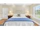 Comfortable bedroom featuring a white metal frame bed, wood floors, and light-filled window at 39 Gabrielle Ct, Stockbridge, GA 30281