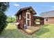 Wooden chicken coop featuring a run, nesting box, and shingled roof at 39 Gabrielle Ct, Stockbridge, GA 30281
