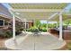 Covered patio featuring string lights, a dining table, built in outdoor kitchen, and beautiful greenery at 39 Gabrielle Ct, Stockbridge, GA 30281