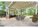 Spacious covered patio with a built-in grill, outdoor seating, and a well-maintained backyard at 39 Gabrielle Ct, Stockbridge, GA 30281