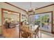 Charming dining room with wood floors and a chandelier, adjacent to a comfortable living area and patio doors at 39 Gabrielle Ct, Stockbridge, GA 30281