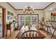 This dining room is a bright space with a chandelier, wood accents, and access to the kitchen at 39 Gabrielle Ct, Stockbridge, GA 30281