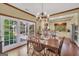 Inviting dining room featuring wood floors, chandelier, and access to a patio with abundant natural light at 39 Gabrielle Ct, Stockbridge, GA 30281