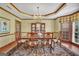 Formal dining room featuring chandelier, rug, and view to bay window at 39 Gabrielle Ct, Stockbridge, GA 30281