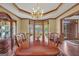 Formal dining room with wood trim, bay window, chandelier, and seating for eight at 39 Gabrielle Ct, Stockbridge, GA 30281