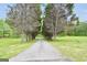 Long private driveway lined with mature trees, leading to a secluded property at 39 Gabrielle Ct, Stockbridge, GA 30281