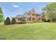 Beautiful brick home with a vast green lawn and professionally landscaped bushes at 39 Gabrielle Ct, Stockbridge, GA 30281