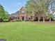 Charming two-story brick home with a manicured green lawn at 39 Gabrielle Ct, Stockbridge, GA 30281