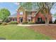 Traditional brick home with a lush green lawn, sidewalk, and mature landscaping at 39 Gabrielle Ct, Stockbridge, GA 30281