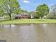 Stately brick home overlooking a serene pond and lush landscape, offering privacy and elegance at 39 Gabrielle Ct, Stockbridge, GA 30281