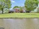 A stately brick home with manicured lawn, mature trees, and charming details on a picturesque lot at 39 Gabrielle Ct, Stockbridge, GA 30281