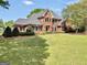 Elegant brick home featuring a well-manicured lawn and classic architectural details at 39 Gabrielle Ct, Stockbridge, GA 30281