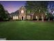 Attractive brick home with a neatly landscaped lawn at twilight at 39 Gabrielle Ct, Stockbridge, GA 30281