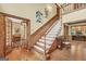 Welcoming foyer with hardwood floors, staircase, and views into the living spaces with French doors at 39 Gabrielle Ct, Stockbridge, GA 30281