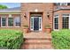 Inviting front entrance with brick steps, potted plants, and stylish black door at 39 Gabrielle Ct, Stockbridge, GA 30281