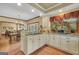 Open kitchen with white cabinetry, island with seating, and view to dining area at 39 Gabrielle Ct, Stockbridge, GA 30281