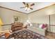 Cozy living room featuring a ceiling fan, comfortable seating, and a vintage piano at 39 Gabrielle Ct, Stockbridge, GA 30281