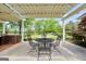 Outdoor kitchen area with a built-in grill, brick accents, and covered pergola with string lights at 39 Gabrielle Ct, Stockbridge, GA 30281