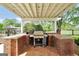 Close up of outdoor kitchen featuring a built-in grill and brick counter-space at 39 Gabrielle Ct, Stockbridge, GA 30281