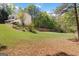 Spacious backyard featuring lush green grass and a beautiful tree line at 3065 Willow Park Dr, Dacula, GA 30019