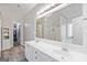 Bathroom with double vanity, framed mirror, and access to closet at 3065 Willow Park Dr, Dacula, GA 30019