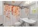 Cozy bathroom featuring a vanity sink and a shower with a colorful autumn-themed curtain at 3065 Willow Park Dr, Dacula, GA 30019