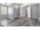 Bright bedroom showcasing hardwood floors, window and neutral paint at 3065 Willow Park Dr, Dacula, GA 30019