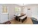 Charming dining area with a wooden table, bench seating, and a door to the backyard at 3065 Willow Park Dr, Dacula, GA 30019