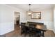 An inviting dining room with wainscoting, hardwood floors, and a modern, geometric pendant light at 3065 Willow Park Dr, Dacula, GA 30019