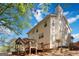 Backyard view of the home featuring a wooden deck and lush surrounding greenery at 3065 Willow Park Dr, Dacula, GA 30019