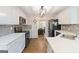Bright kitchen featuring white cabinets, gray backsplash, stainless steel appliances, and hardwood flooring at 3065 Willow Park Dr, Dacula, GA 30019