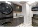 Well-appointed laundry room featuring a stackable washer/dryer and modern granite countertops at 3065 Willow Park Dr, Dacula, GA 30019