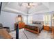 Spacious main bedroom with tray ceiling, fan and wood furniture at 3065 Willow Park Dr, Dacula, GA 30019