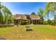 Expansive backyard featuring a covered patio and lush green lawn, ideal for outdoor enjoyment at 410 Wicklow St, Tyrone, GA 30290