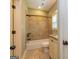 Bathroom features neutral wall colors and tilework, bathtub with shower, and a vanity sink with granite countertop at 410 Wicklow St, Tyrone, GA 30290