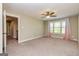 This bedroom features a large window, neutral walls, and a ceiling fan at 410 Wicklow St, Tyrone, GA 30290