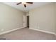 Bedroom features a ceiling fan, neutral walls, plush carpeting, and an open doorway to another room at 410 Wicklow St, Tyrone, GA 30290