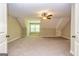 Large bedroom features neutral colored walls, plush carpeting, ceiling fan, and a window for natural lighting at 410 Wicklow St, Tyrone, GA 30290