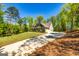 An exterior view of the home and driveway surrounded by trees at 410 Wicklow St, Tyrone, GA 30290