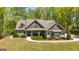 Lovely house with stone detailing, an inviting front porch, and a curved front walkway at 410 Wicklow St, Tyrone, GA 30290