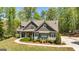 Beautiful home with stone accents, a covered porch, and a walkway through the front yard at 410 Wicklow St, Tyrone, GA 30290