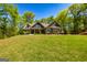 Charming home featuring lush landscaping and a well-manicured lawn at 410 Wicklow St, Tyrone, GA 30290