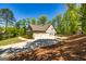 Side exterior view featuring a three car garage with driveway at 410 Wicklow St, Tyrone, GA 30290