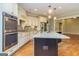 Kitchen with stainless steel appliances, granite countertops, and a large kitchen island at 410 Wicklow St, Tyrone, GA 30290
